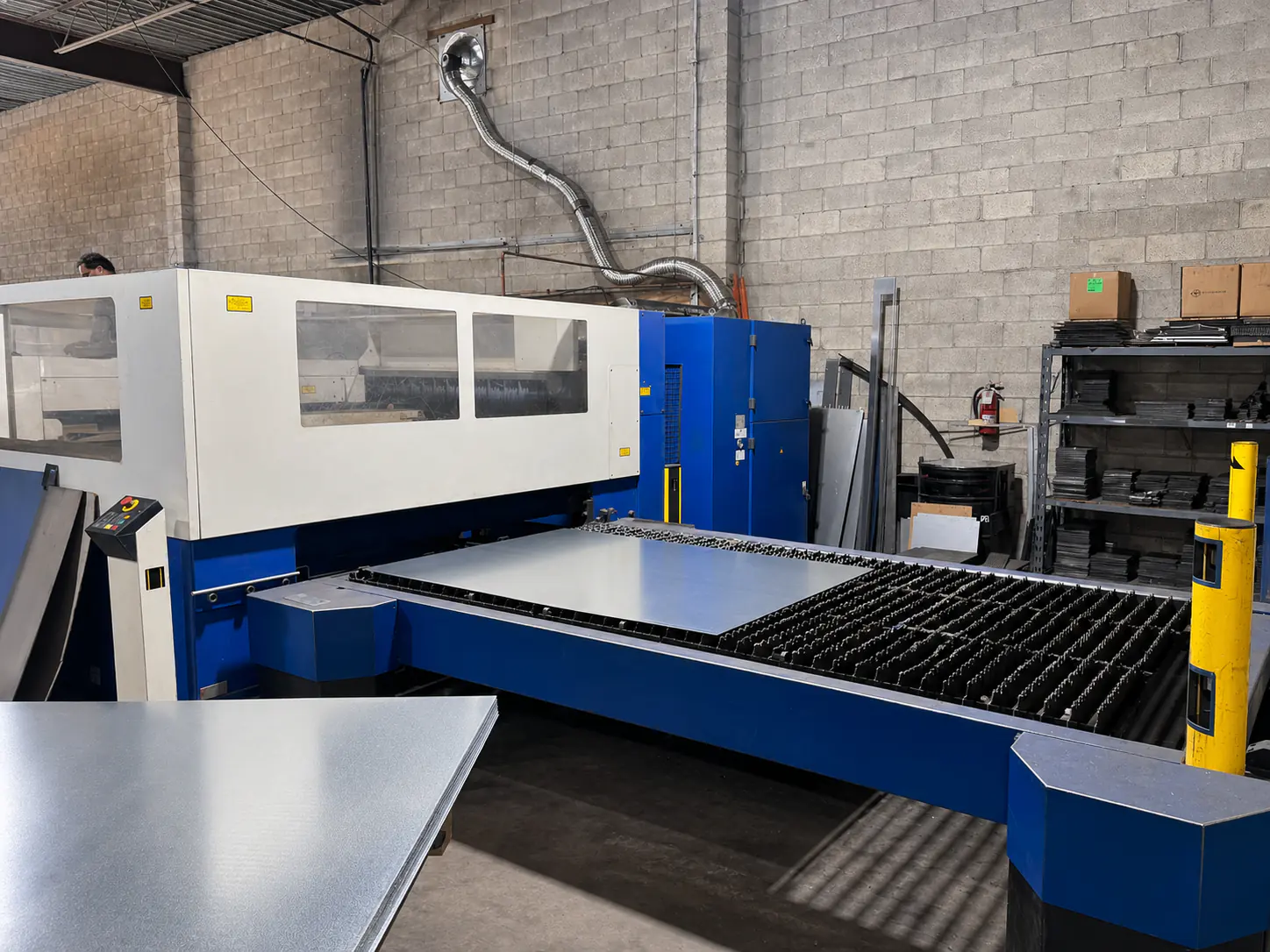 Tube Laser in Operation — Tube laser cutting in production — the TRUMPF tube laser cutting profiles in our Brampton shop. 3D miters and copes happen in a single setup; tube ends come off the bed weld-ready for the next station.